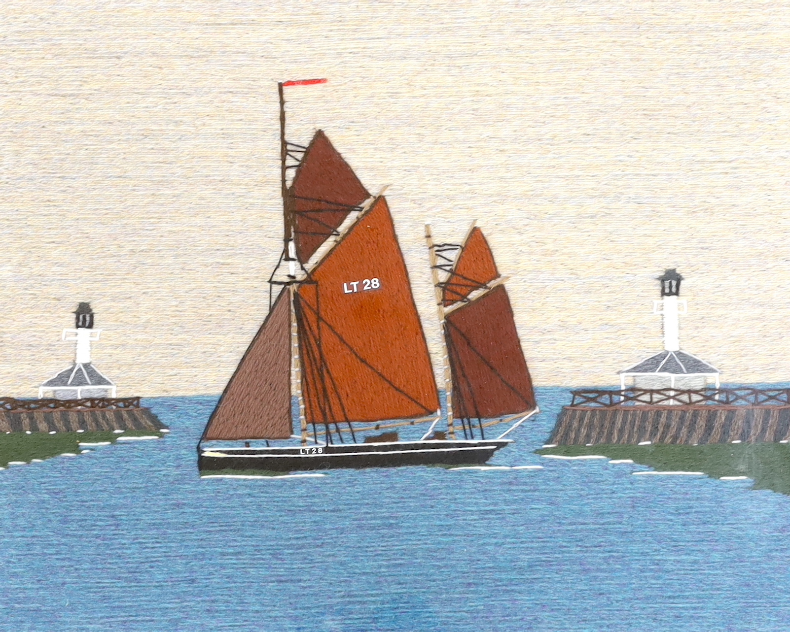 A long stitch wool work embroidery of ‘The Lowestoft Ketch Susie LT28’, in a harbour mouth, 20th century, 35.5 x 44cm.